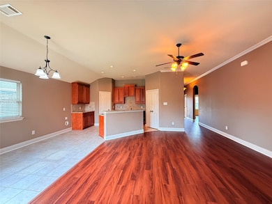 Unfurnished living room with arched walkways, a chandelier, plenty of natural light, light wood-type flooring, and vaulted ceiling