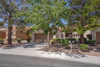 View of front of home featuring stucco siding, a g