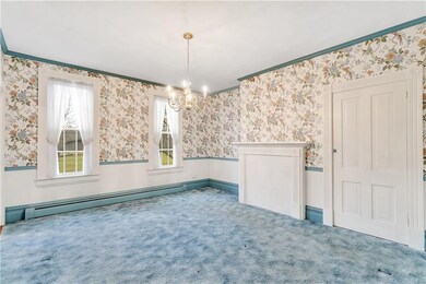 The formal dining room boasts high ceilings & is l