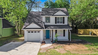 Traditional home with a garage, a porch, roof with