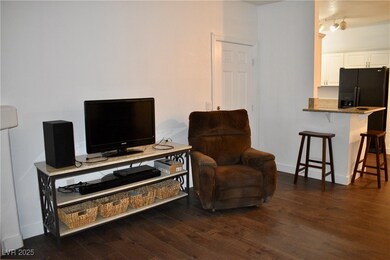 Living room featuring dark wood-look vinyl finishe