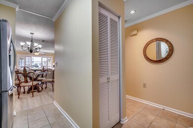 Hall featuring a textured ceiling, light tile patt