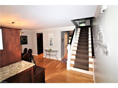 Welcoming Foyer features a Custom Cherry Shoe Cabi