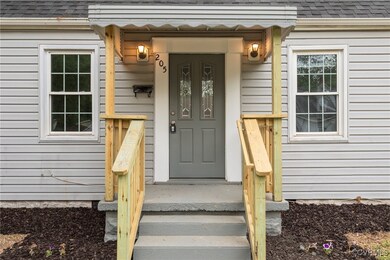 Entrance to property featuring roof with shingles