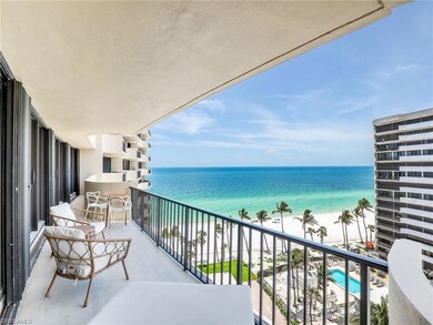Balcony featuring view of water and beach
