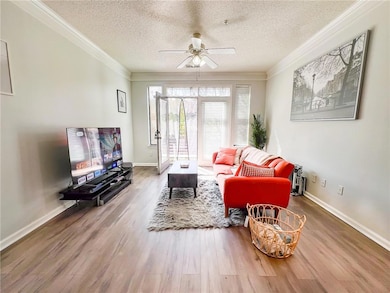 Living room featuring crown molding, ceiling fan, 