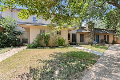 Inviting front entrance with well-maintained green space on the front