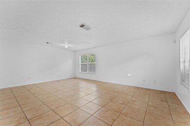 Unfurnished room with a textured ceiling and ligh