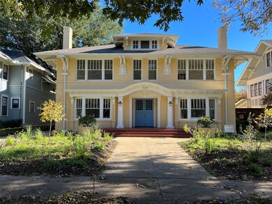 View of front facade with stucco siding and a chim