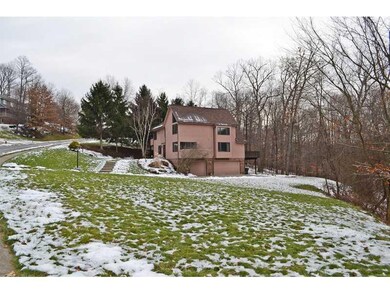 Exterior Front. Large side yard and wooded rear ya