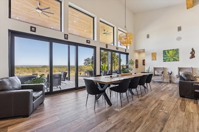 Dining room with a ceiling fan, light wood finish