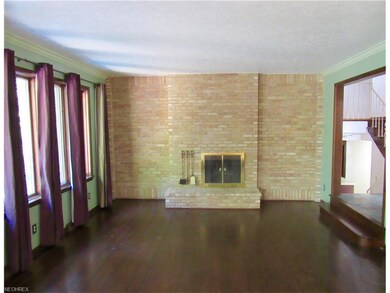 Living room with wood floors  and wood burning fir