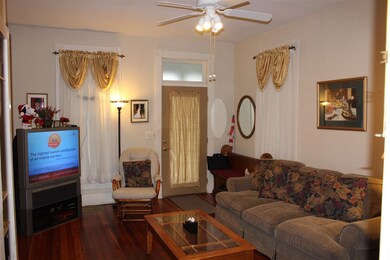 This spacious living room offers a ceiling fan and