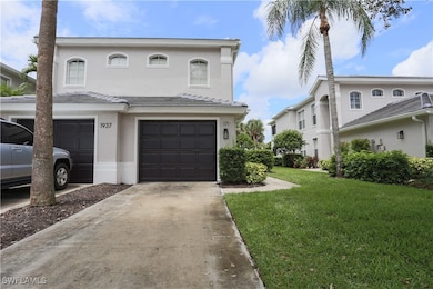 View of front of property with an attached garage, driveway, stucco siding, and a front yard