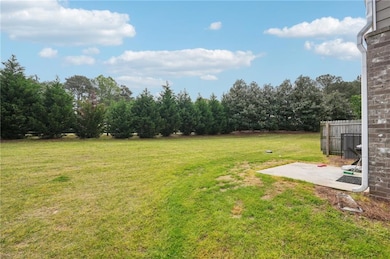 View of yard featuring fence and a patio area