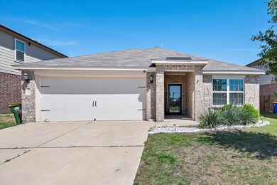 View of front of house with a garage and a front lawn