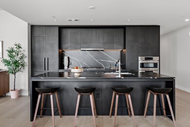Kitchen with light wood-style flooring, stainless