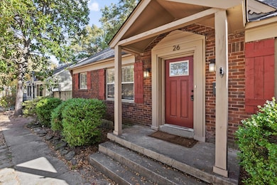 Entrance to property with brick siding and roof with shingles