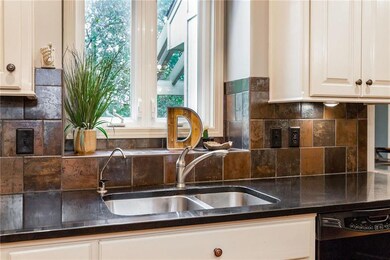 Rich Silestone counters and a full tile backsplash