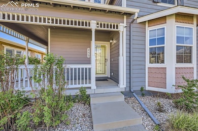 Doorway to property featuring covered porch