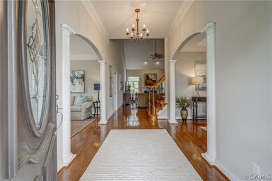 Entryway featuring hardwood flooring, crown moldin