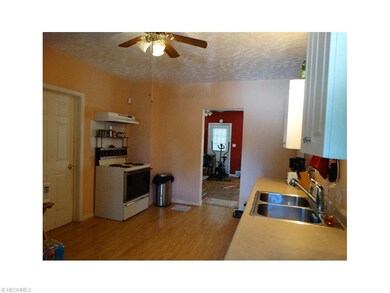 Large open kitchen with laminate flooring.  Bathro