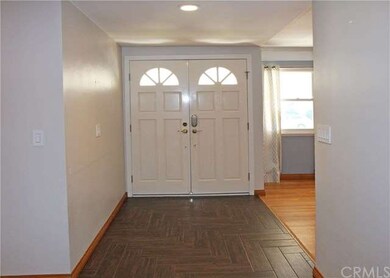 Enter through the double doors to the wood look ti