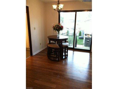 Eat in kitchen with hardwood floors and leading to private patio/backyard