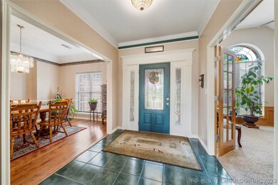 Beautiful tile foyer with wood trimmed door and so