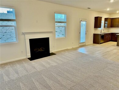 Unfurnished living room featuring light carpet, a fireplace with flush hearth, and recessed lighting