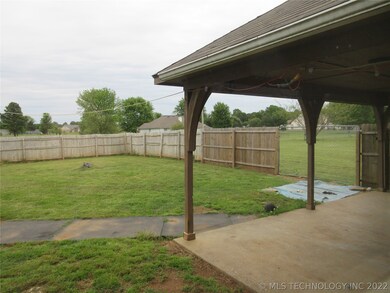 Covered patio in backyard.