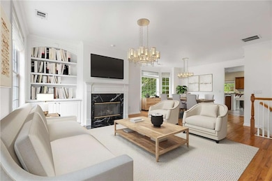 Large living room with marble fireplace and built-