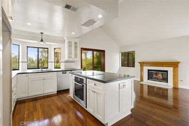 Custom designed kitchen features center island, newer appliances, volume ceilings