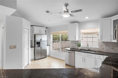 Kitchen with white cabinets, stainless steel appli
