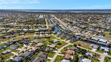 Birds eye view of property with a water view and a