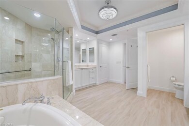 Bathroom with a shower stall, a garden tub, crown 
