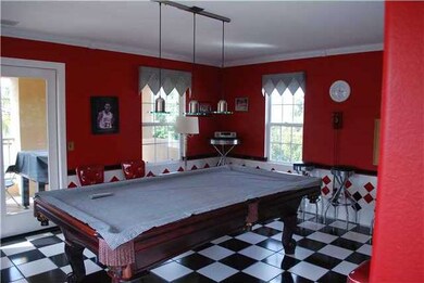 50's inspired game room, very cool!  Is technically a bedroom.  Has a bathroom and shower and large closet.  Off this room is a large covered balcony with views of the neighborhood, cul de sac and neighboring hillsides. Great place to watch the kids 