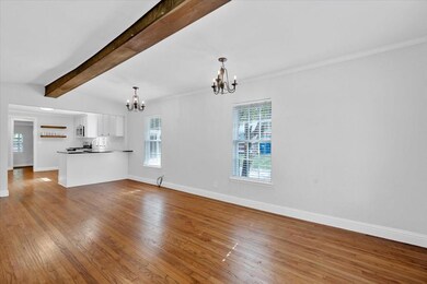 Unfurnished living room with beamed ceiling, a not