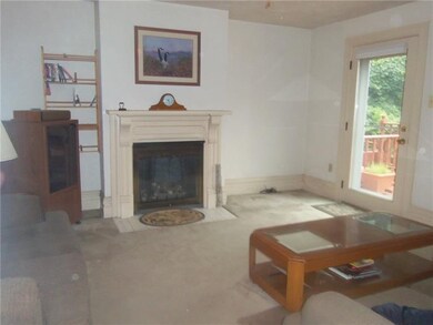 Spacious living room with fireplace opens to the r
