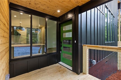 Entryway featuring wood finished floors, recessed lighting, plenty of natural light, wooden walls, and wooden ceiling