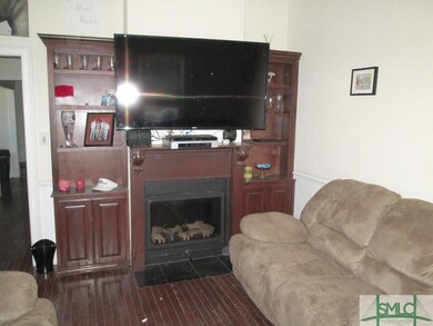 Large living room with built-ins, fireplace and ha
