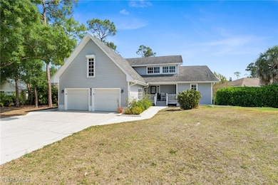 Traditional home featuring a front yard, a shingle