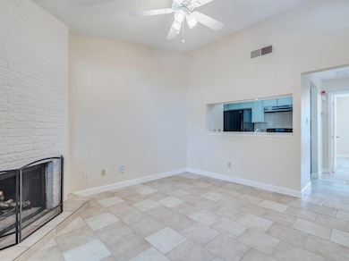 Unfurnished living room with ceiling fan, a brick