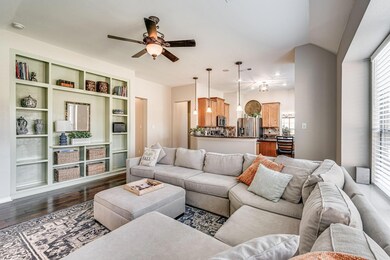 Living room featuring lofted ceiling, dark wood-ty