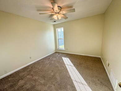 Spare room featuring carpet, ceiling fan, and baseboards