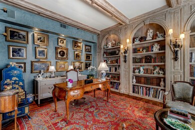 Office featuring wood finished floors, beam ceiling, and built in shelves