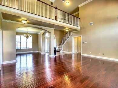 Photo. Open floorplan with high ceilings, stairs o