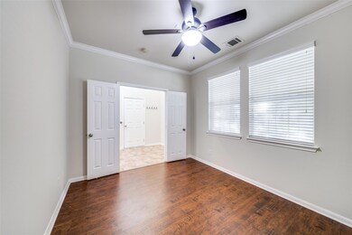 Unfurnished bedroom with crown molding, wood fini