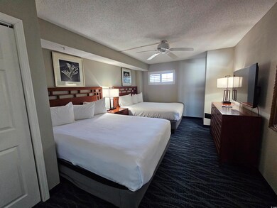 Bedroom featuring ceiling fan, a textured ceiling,