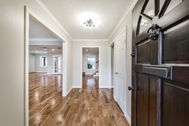 Welcoming entryway with hardwood floors, leading t